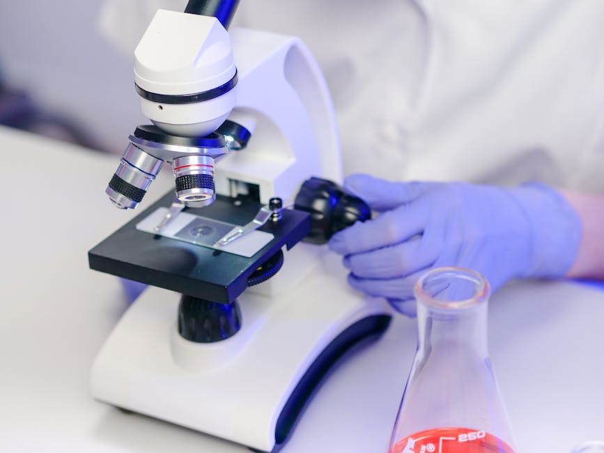 Close-up of a scientist examining slides in a modern lab.