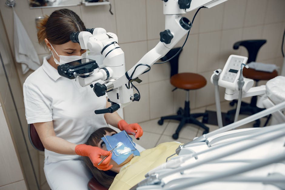 Dentist using advanced microscope for precise dental treatment in clinic.